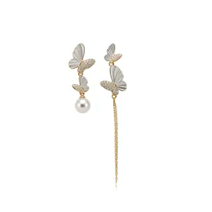 Asymmetric butterfly drop earrings with white pearl and long gold-tone tassel chain