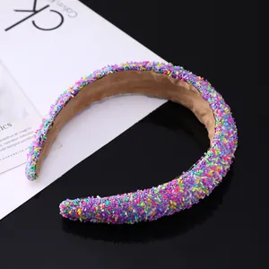 Macro detail of rainbow glitter sponge headband with premium brown velvet lining