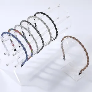 Sparkling crystal twist headbands in various colors on acrylic display stands