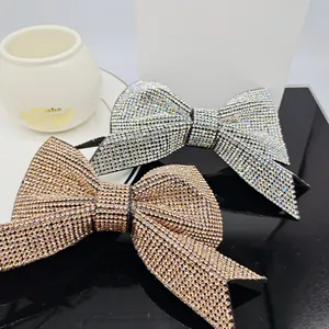 Close-up of sparkling rhinestone bow hair clips in elegant rose gold and silver finishes