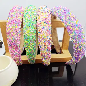 Detail of colorful sprinkle padded headbands hanging on a wooden display rack