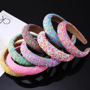 Detailed close-up of rainbow glitter chunky headbands with colorful bead texture
