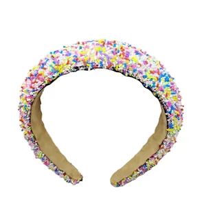 Close-up of rainbow sprinkle glitter on a wide padded baroque sponge headband