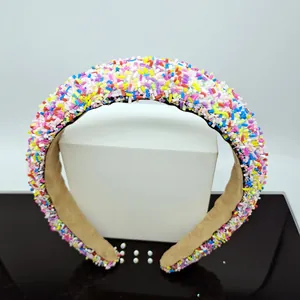 Detailed close-up of rainbow glitter sponge headband with soft velvet inner lining texture