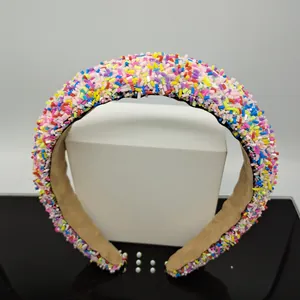 Close-up of a wide padded headband covered in colorful sprinkles with anti-slip brown lining
