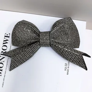 Sparkling dark grey rhinestone bow hair clip with luxury spring clip back on a white background