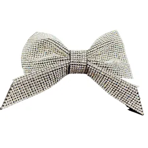 Sparkling silver bow hair clip encrusted with clear rhinestones for elegant styling