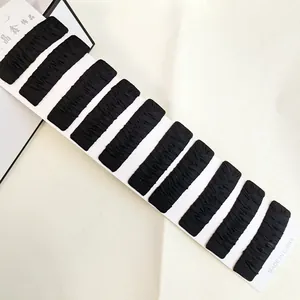 Set of 10 black fabric covered BB hair clips arranged on a white display card