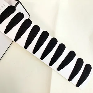 Detail of 10-piece black fabric wrapped snap hair clips on a white display card