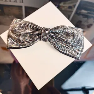 Détail d'une élégante pince à cheveux nœud avec strass brillants sur boîte cadeau