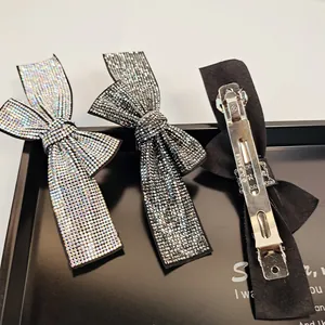 Detailed back view of vintage rhinestone bow hair clip with metal spring mechanism