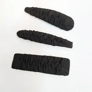 Close-up of three black fabric-wrapped hair clips with handmade pleated texture and finish