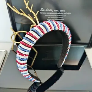 Handmade beaded wide headband with red white and blue striped beads on a black stand