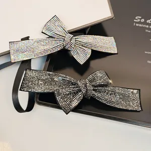 Close-up of sparkling rhinestone bow hair clips in colorful and gunmetal grey crystals