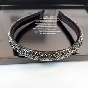 Detalle macro de diamantes de imitación negros en diadema de satén de lujo