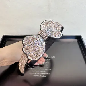 Macro detail of luxury rhinestone bow headband with shimmering multi-color crystals