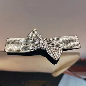 Close-up of sparkling rhinestone bow hair clip with luxury double-layer crystal design