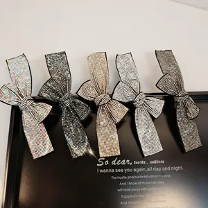 Set of five elegant bow hair clips with shimmering rhinestones in assorted metallic colors