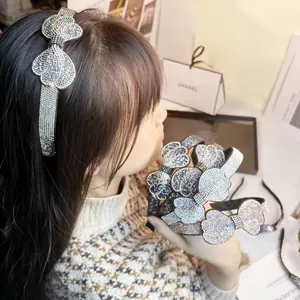 Detailed view of luxury rhinestone bow headband on model with elegant crystal accents