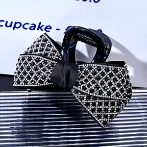 Detailed view of the elegant rhinestone bow hair claw clip with sparkling mesh pattern