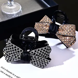 Sparkling rhinestone bow hair claw clips in elegant black and champagne gold colors