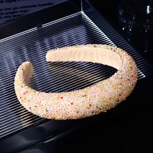 Close-up of elegant wide headband featuring dense colorful crystal beads and soft lining
