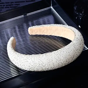 Close-up of wide crystal headband with silver beads and non-slip velvet lining