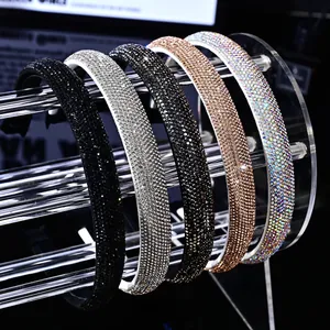 Sparkling rhinestone headband set in black silver and gold colors on acrylic stand
