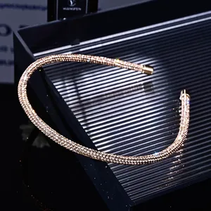 Close-up of rose gold rhinestone headband with sparkling crystals on black display tray