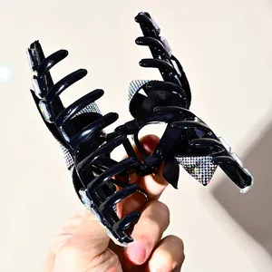 Sparkling bow hair claw clip with colorful rhinestones and crystals in black finish