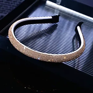 Detailed close-up of champagne gold rhinestone headband with sparkling pavé crystals