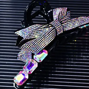 Macro detail of bow hair claw clip with rhinestones and large AB crystals on black finish