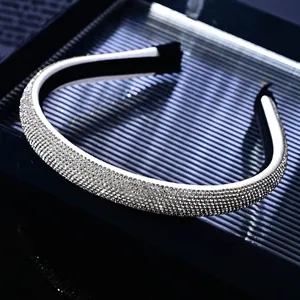 Detailed close-up showing luxury silver-white rhinestones on a slim headband accessory