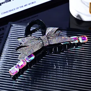 Elegant black bow hair claw clip with sparkling rhinestones and iridescent gemstones