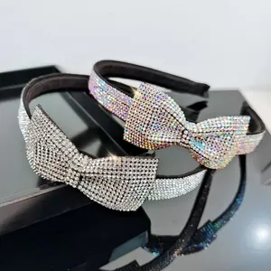 Detail of sparkling rhinestone bow headband with intricate crystal pavé and glossy finish