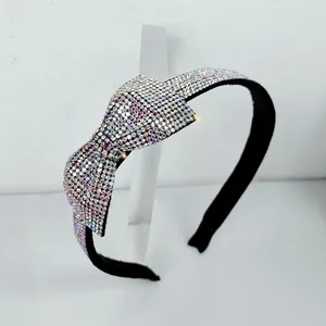 Detailed close-up of rainbow rhinestone bow headband with shimmering AB crystals