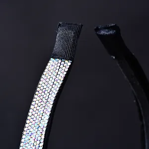 Macro detail of the iridescent AB rhinestones on the black fabric headband with soft end wrap