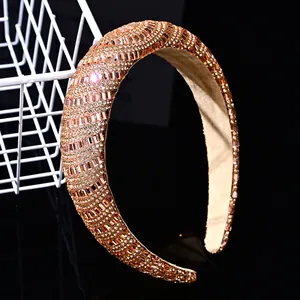Detailed macro view of luxury padded headband with champagne gold sparkling rhinestones