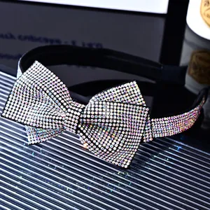 Close-up of luxury velvet headband with sparkling rainbow rhinestones in bow design