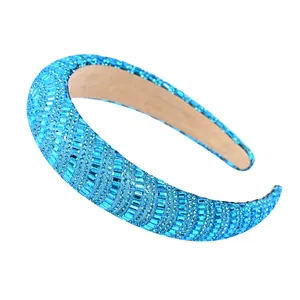 Macro shot of padded electric blue headband with sparkling rhinestones on white background