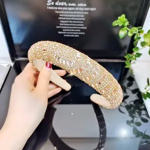 Detailed view of the champagne crystal padded headband with sparkling geometric rhinestones