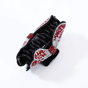 Macro detail of French vintage hair claw clip with red and white sparkling rhinestones