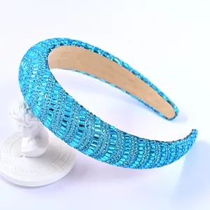 Macro shot of blue crystal rhinestones on padded sponge headband with plush lining