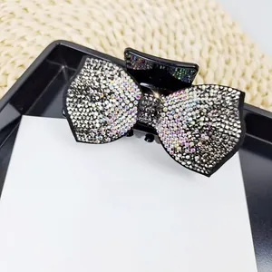 Close-up of sparkling colorful rhinestones on an elegant bow-shaped hair claw clip