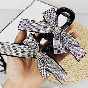 Detail of rhinestone bow hair claw clips with anti-slip teeth and sparkling finish