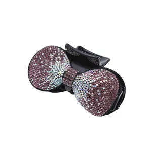 Detail of the elegant bow-shaped hair claw with shimmering purple and AB crystals