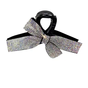 Detail of elegant bow hair claw with colorful rhinestones and premium black finish