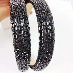 Detailed macro view of high-quality black rhinestones on a wide vintage-style headband