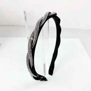 Sparkling rhinestone twist headband for women with black base and cross knot design