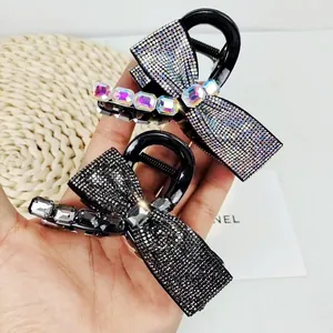Elegant bow hair claw clip with rhinestones in black and iridescent crystal finish